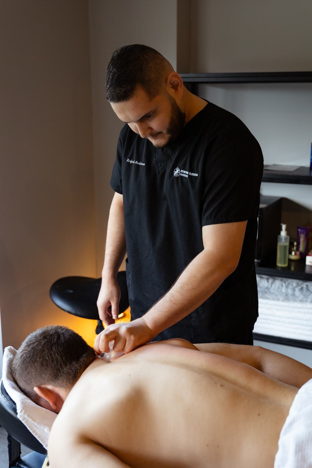 Rafael treating a client's neck and shoulders