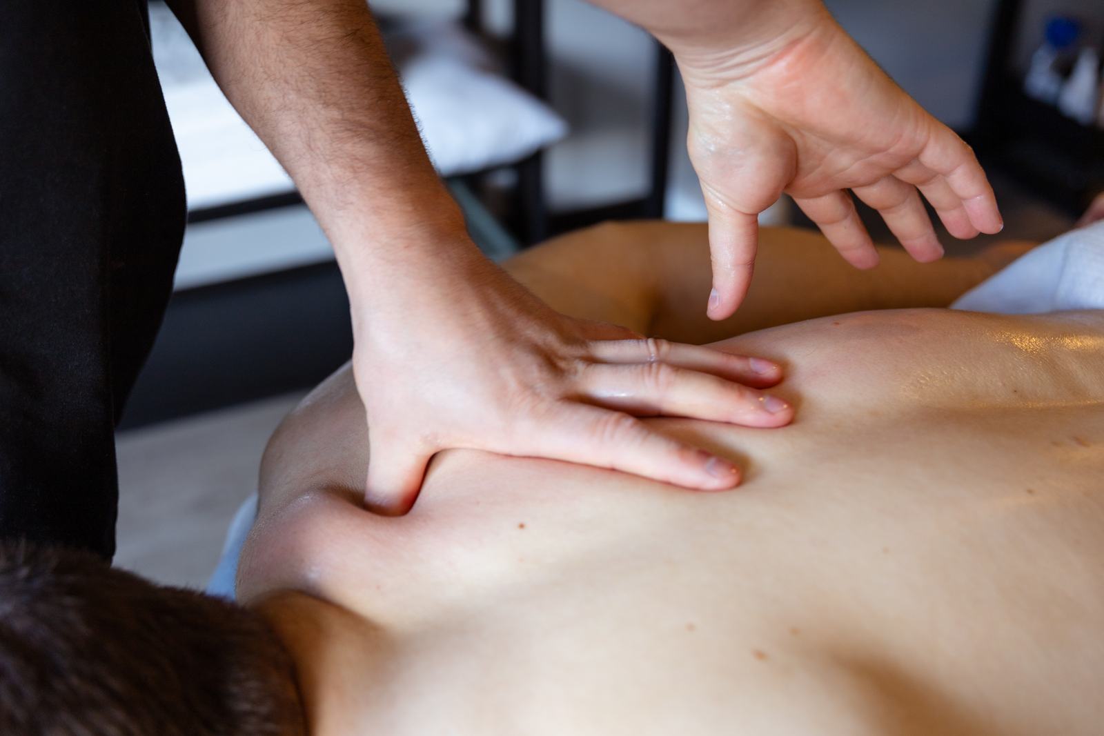 Rafael's hands working on a client's back